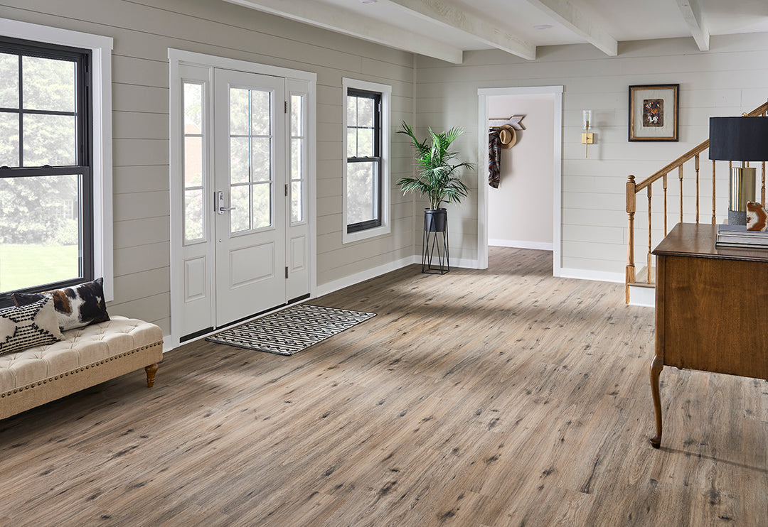 Nature-inspired interior highlighted by Cyrus 2.0 Fauna 7x48 vinyl flooring, where earthy grain patterns lend an organic warmth beneath neutral-toned furniture.
