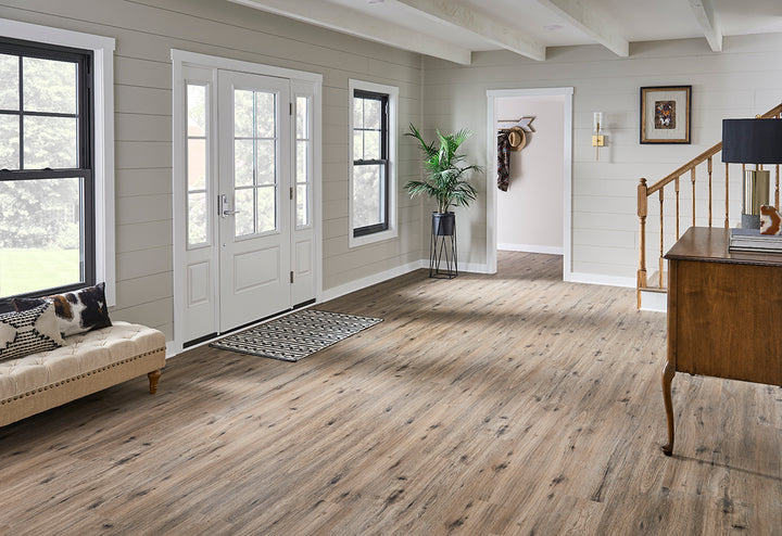 Nature-inspired interior highlighted by Cyrus 2.0 Fauna 7x48 vinyl flooring, where earthy grain patterns lend an organic warmth beneath neutral-toned furniture.