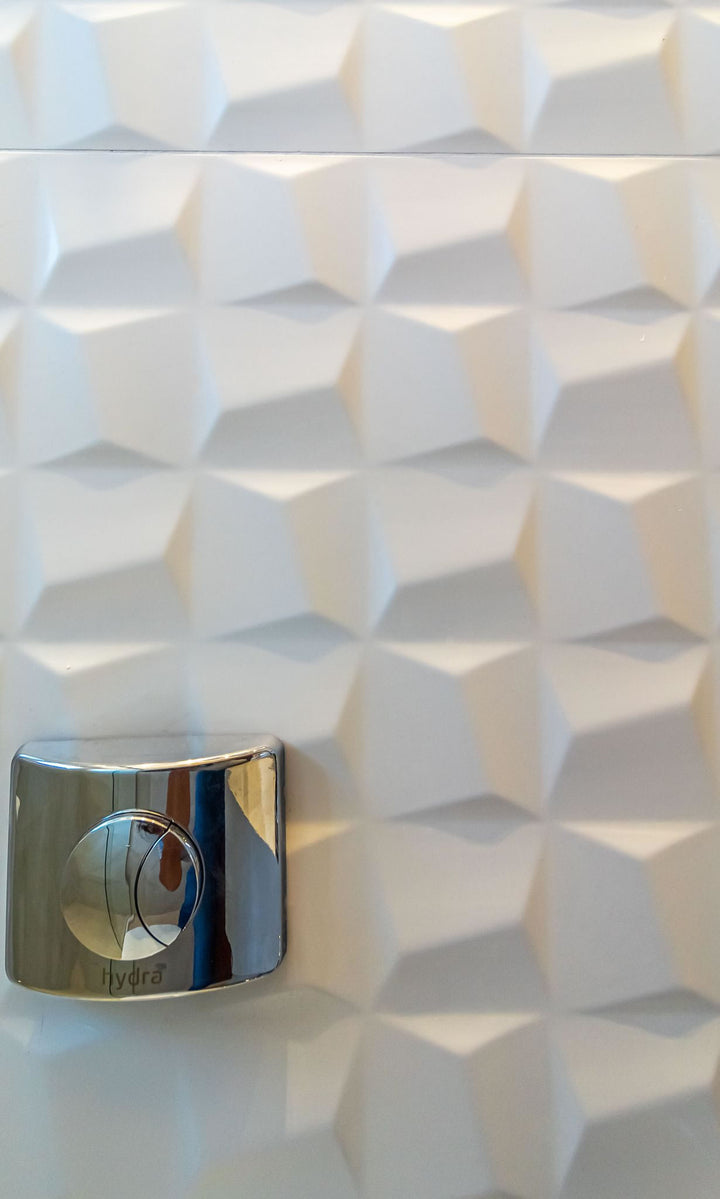 With its sculpted satin surface, the Nuvo Sculptura 12x36 Ceramic Tile brings dimensional detail to a modern space.