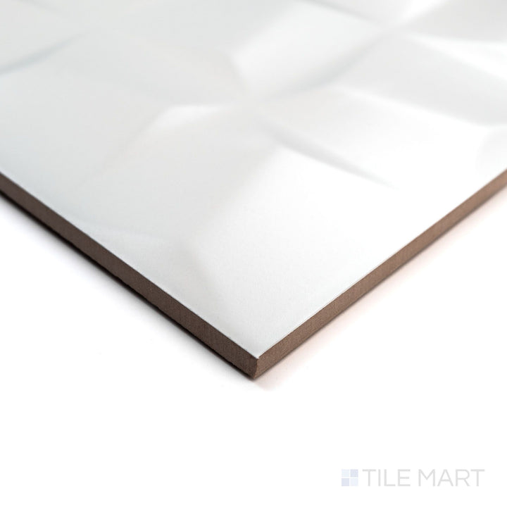 Angled view of Nuvo Sculptura 12x36 Satin Ceramic Tile showing its dimensional sculpted texture and satin finish from a corner perspective.