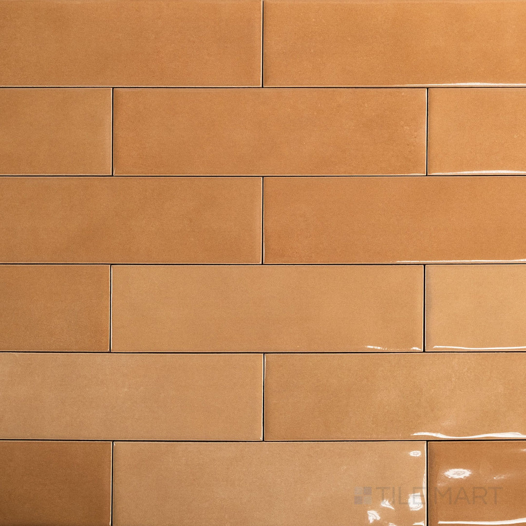Full-tile view of Canvas Orange Peel 3x10 Glossy Ceramic Tile highlighting its bright orange hue and glossy finish in a modern plank-style size.