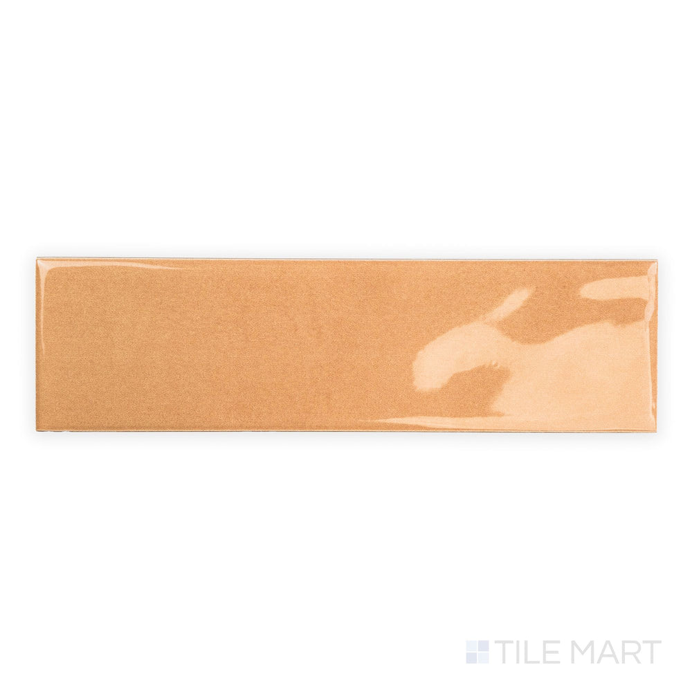 Top-down image of Canvas Orange Peel 3x10 Glossy Ceramic Tile highlighting its bright orange finish and sleek glossy texture across the entire tile.