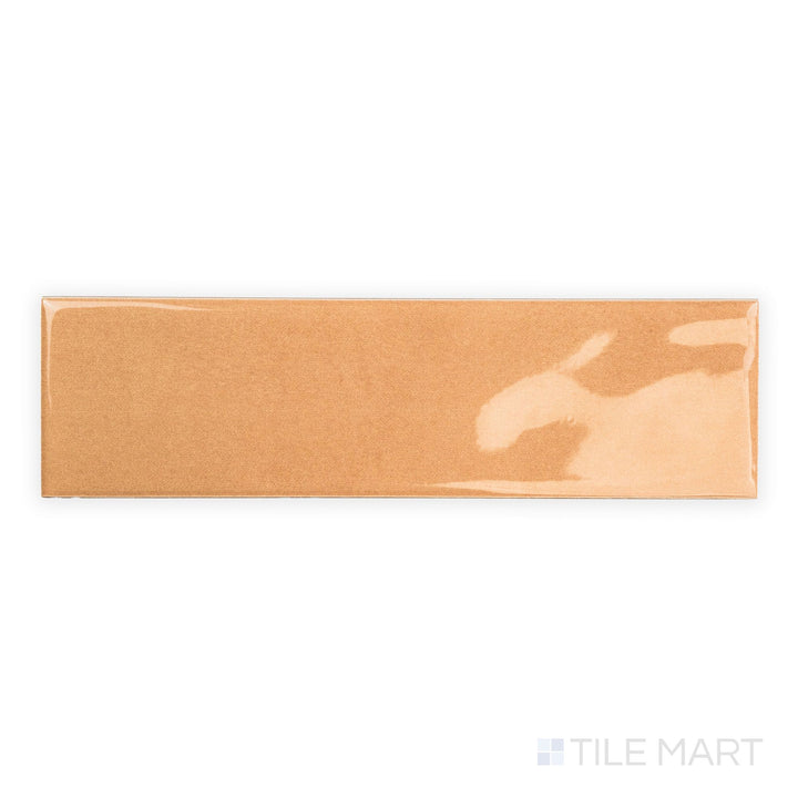Top-down image of Canvas Orange Peel 3x10 Glossy Ceramic Tile highlighting its bright orange finish and sleek glossy texture across the entire tile.