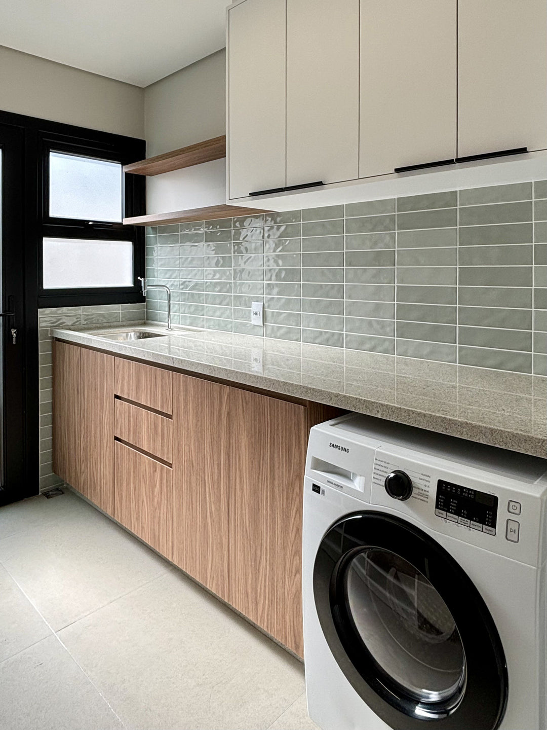 A soft green glaze and high-gloss finish give the Canvas Quiet Sage 3x10 Glossy Ceramic Tile a refined touch in a composed setting.