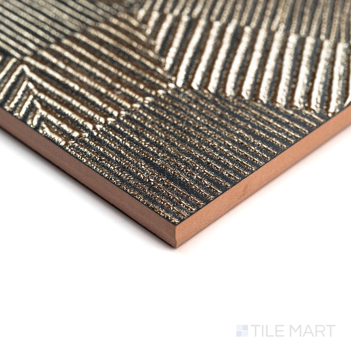 Aurora Gold 12x36 Metallic Ceramic Tile seen in an angled shot, showcasing its radiant gold metallic finish with reflective highlights along the edges.