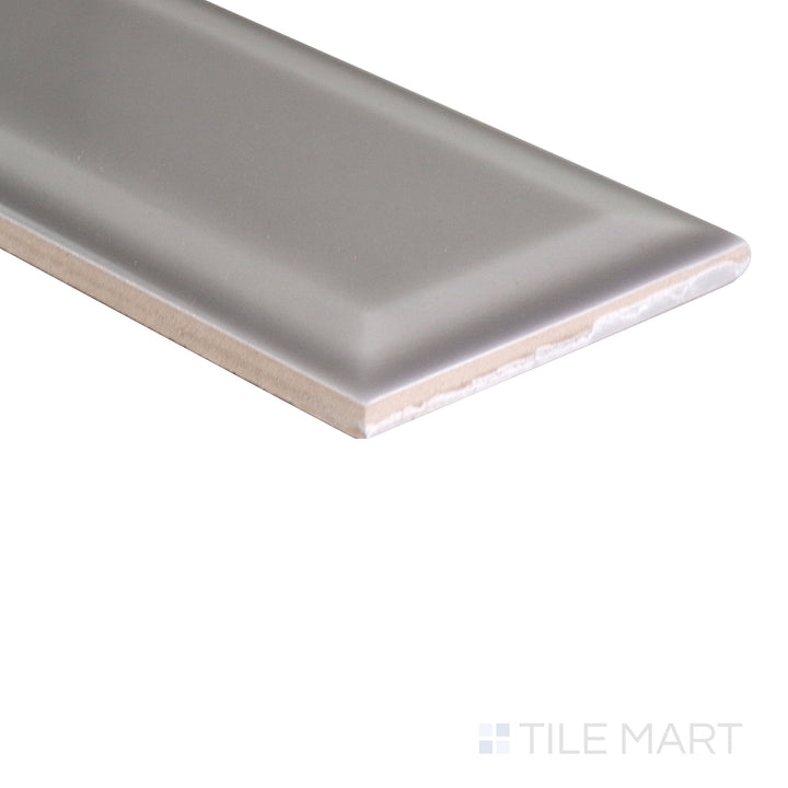 Angled shot showcasing the beige and tan ceramic tile from the Boutique Sleek series, highlighting its smooth surface and refined texture.