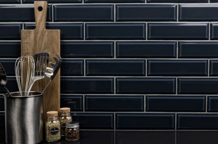 A modern room with indigo blue tiles from the Boutique Sleek series, creating a bold statement against minimalist decor.