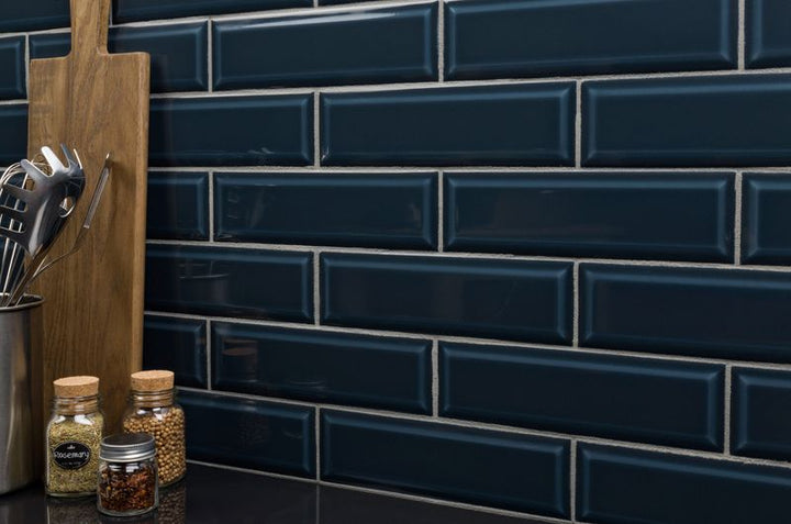 A contemporary setting with Boutique Sleek Indigo 3x9 beveled glossy ceramic tiles, showcasing their deep blue hue and elegant shine in a real-life design.