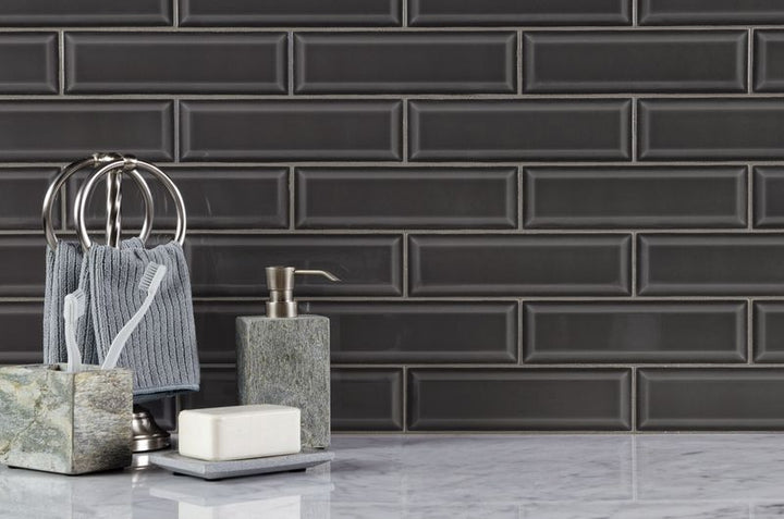 The dark gray and black tile from the Boutique Sleek series adds sophistication and depth to this contemporary space.