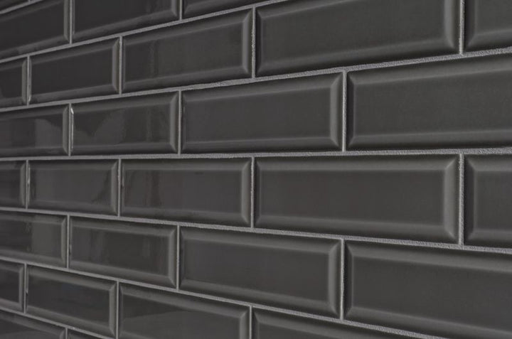 A sophisticated room scene with Boutique Sleek Sable 3x9 beveled glossy ceramic tiles, enhancing the space with a rich dark shade and a high-gloss sheen.