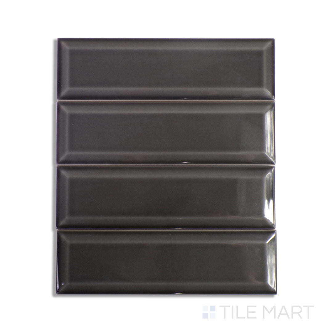 A dark gray and black ceramic tile, featuring a glossy surface that enhances depth and texture in contemporary spaces.