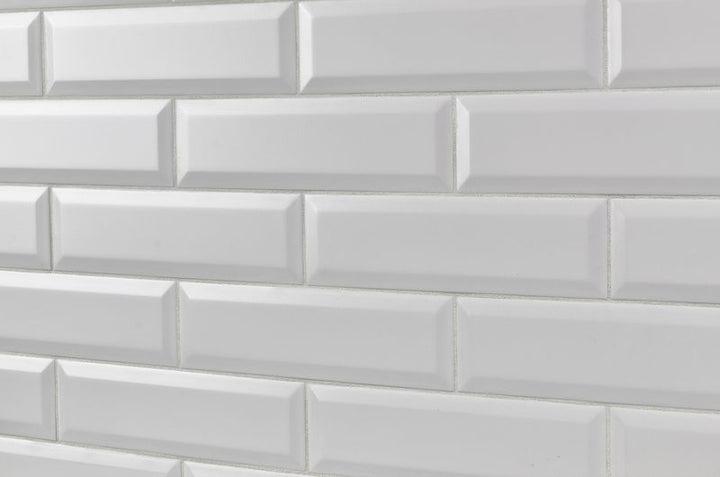 A minimalist interior featuring Boutique Sleek Salt 3x9 beveled matte ceramic tiles, providing a soft, refined look with a subtle textured surface.