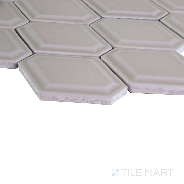 An angled view of the indigo blue tile from the Boutique Sleek series, emphasizing its glossy finish and bold color.