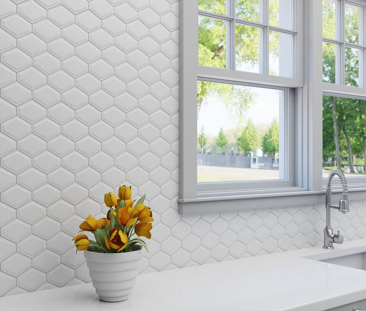 A contemporary setting with Foundations Plaster Structure Elongated Hex glossy ceramic mosaic, emphasizing its unique geometric pattern and sleek glaze.