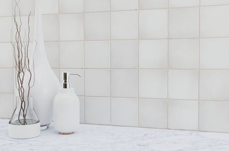 The dark gray and black tile from the Boutique Sleek series adds sophistication and depth to this contemporary space.