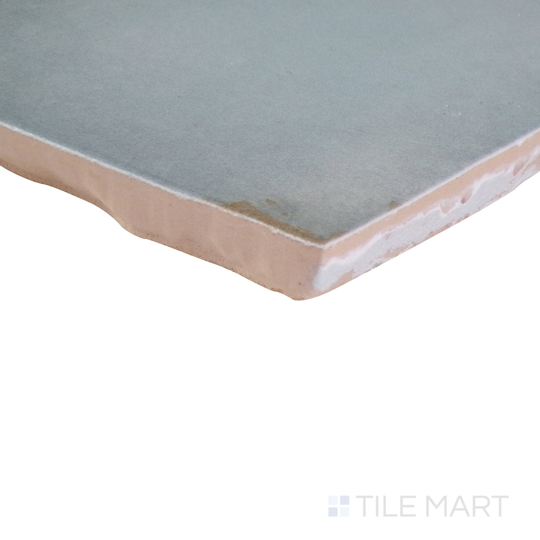 An angled shot of the tan and beige tile, revealing its polished surface and natural color variation.