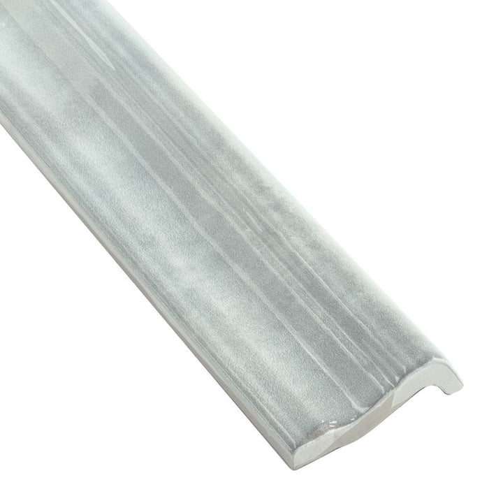 A detailed corner view of Moroccan Habitat Misty 2x12 glossy ceramic chair rail, highlighting its elegant sculpted edge and high-gloss glaze.