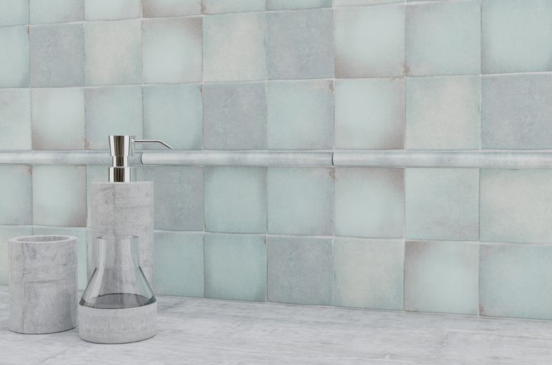 The dark, polished gray tiles bring a sense of sophistication and modernity to this refined space.