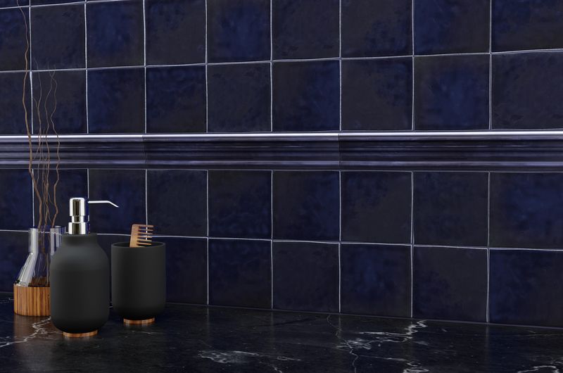 A modern room with indigo blue tiles from the Boutique Sleek series, creating a bold statement against minimalist decor.