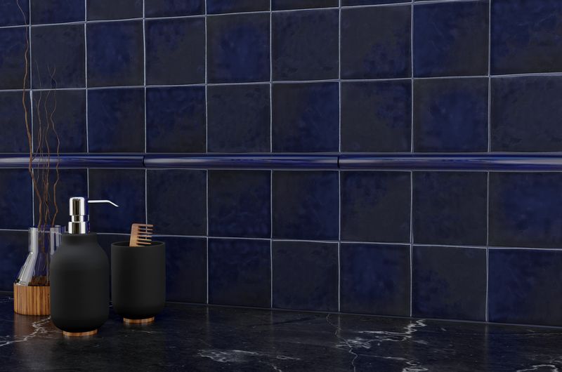 The dark gray and black tile from the Boutique Sleek series adds sophistication and depth to this contemporary space.