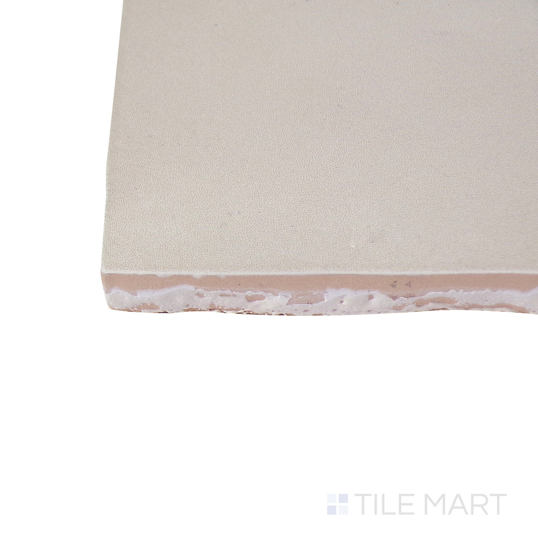 Close-up corner shot of the glossy white tile, showing its ceramic build and sleek edges.