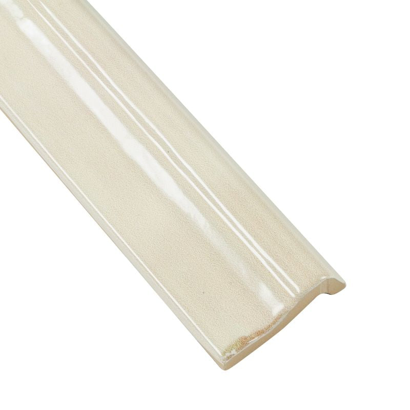 A corner shot of Moroccan Habitat Sand Dune 2x12 glossy ceramic chair rail, showcasing its soft neutral tone and sculpted edge.