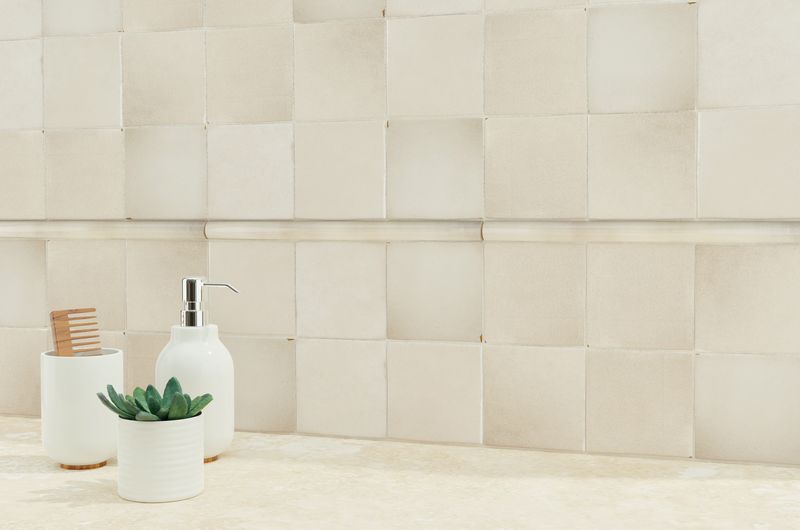 A warm and inviting area with tan and beige tiles, providing a polished, natural backdrop for modern furnishings.