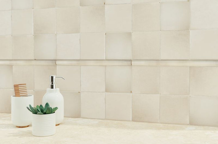 A warm and inviting area with tan and beige tiles, providing a polished, natural backdrop for modern furnishings.