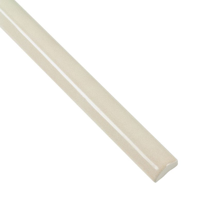 A close-up corner view of Moroccan Habitat Sand Dune 1x12 glossy ceramic pencil trim, featuring its warm undertone and polished glaze.