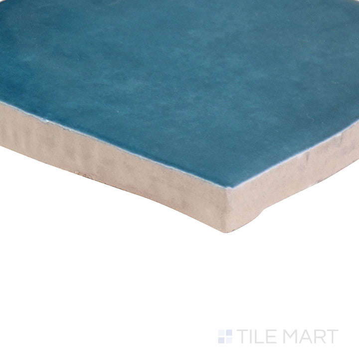 The indigo blue tile from the Boutique Sleek series, captured from an angle to emphasize its striking color and matte finish.