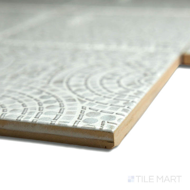 Corner shot of the beige and tan ceramic tile from the Boutique Sleek series, highlighting its material composition and slim profile.