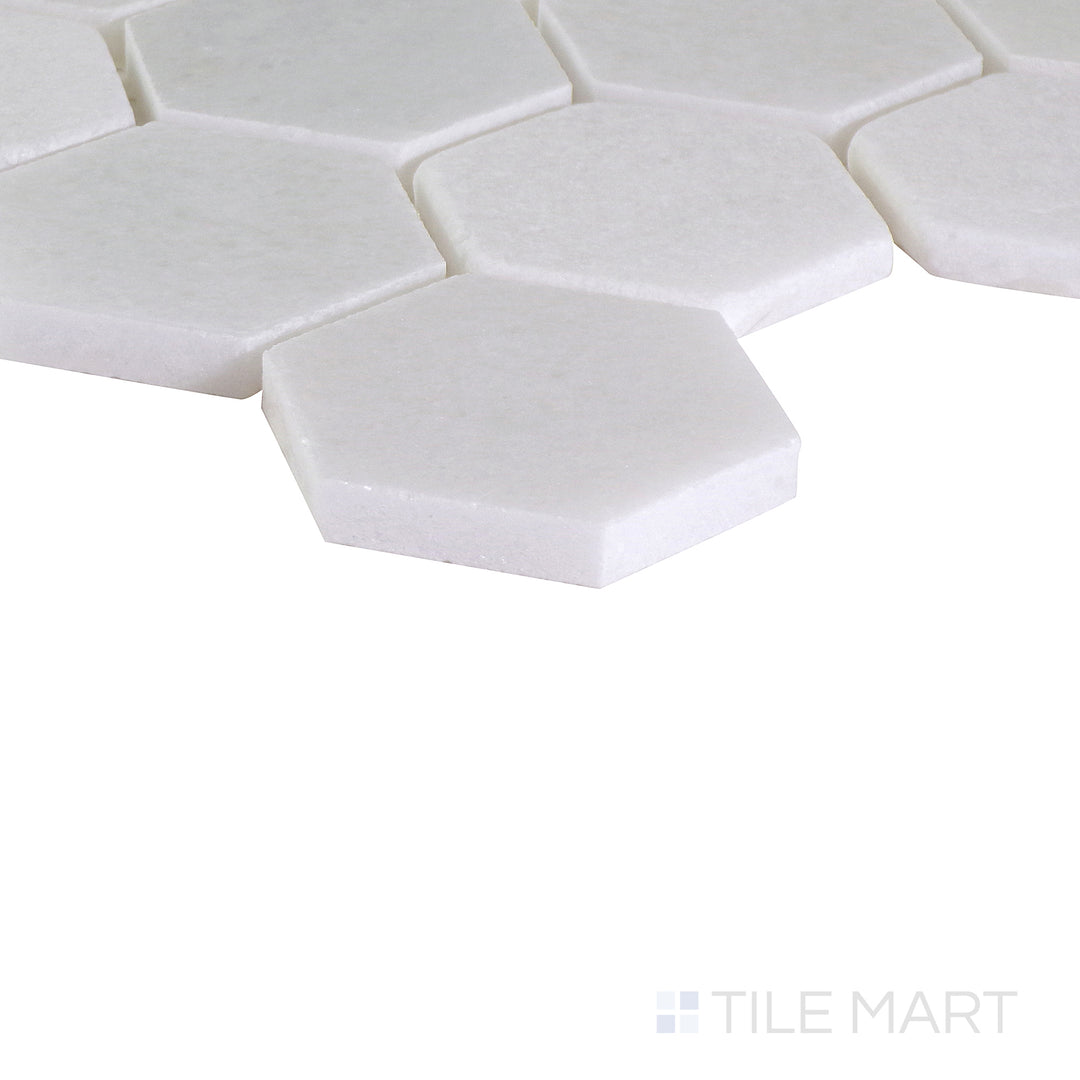 An angled shot of the tan and beige tile, revealing its polished surface and natural color variation.