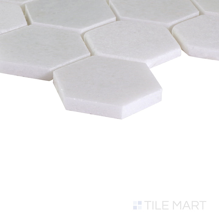 An angled shot of the tan and beige tile, revealing its polished surface and natural color variation.