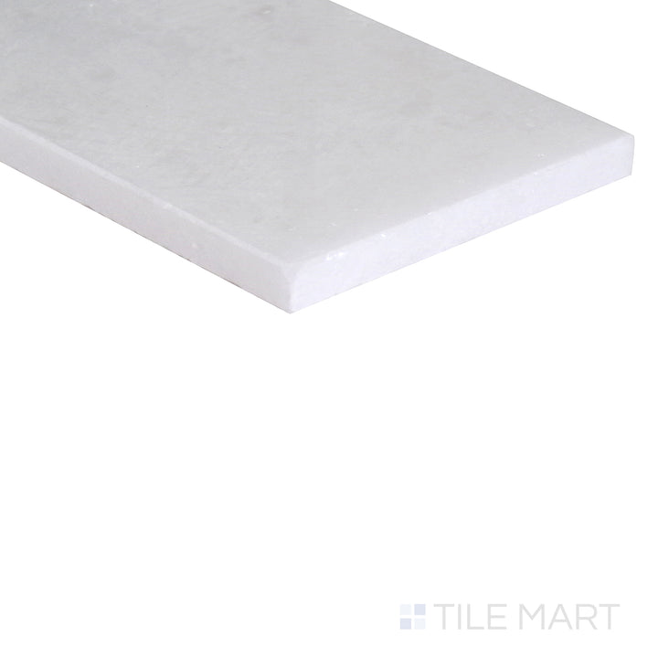 An angled shot of the tan and beige tile, revealing its polished surface and natural color variation.