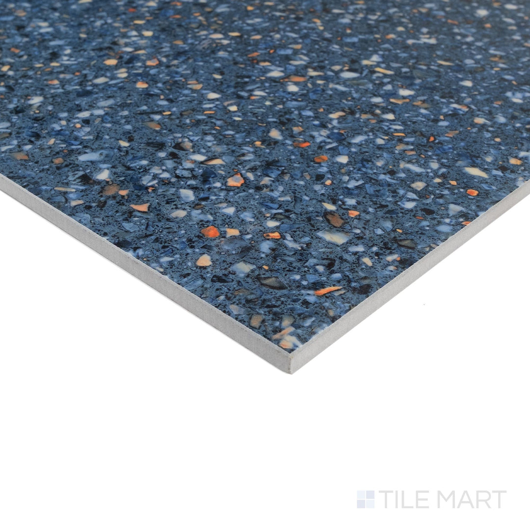 Corner detail of Mystere Blue 24x24 semi gloss porcelain tile highlighting rich color and smooth polished sheen.