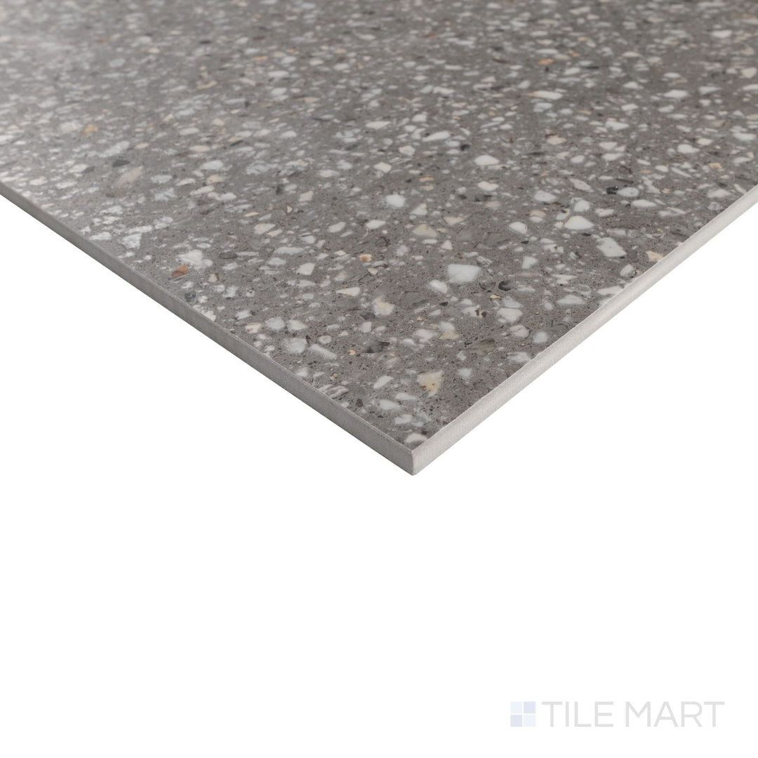 Corner close-up of Mystere Dark Grey 24x24 semi gloss porcelain tile showing sleek surface and subtle light reflection.