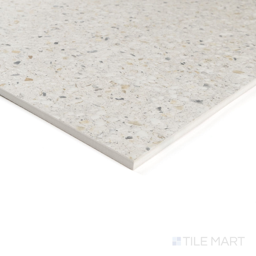 Corner close-up of Mystere Linen 24x24 semi gloss porcelain tile showing warm beige hue and delicate reflective surface.