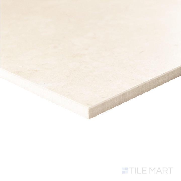 Angled corner view of a 12x12 Palazzo Crema natural porcelain tile revealing its clean edge profile and warm ivory matte finish