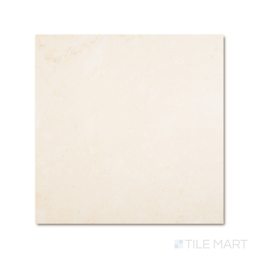 Top-down view of a 24x24 Palazzo Crema natural porcelain tile revealing warm ivory tones across a broad matte surface with gentle stone-like variation