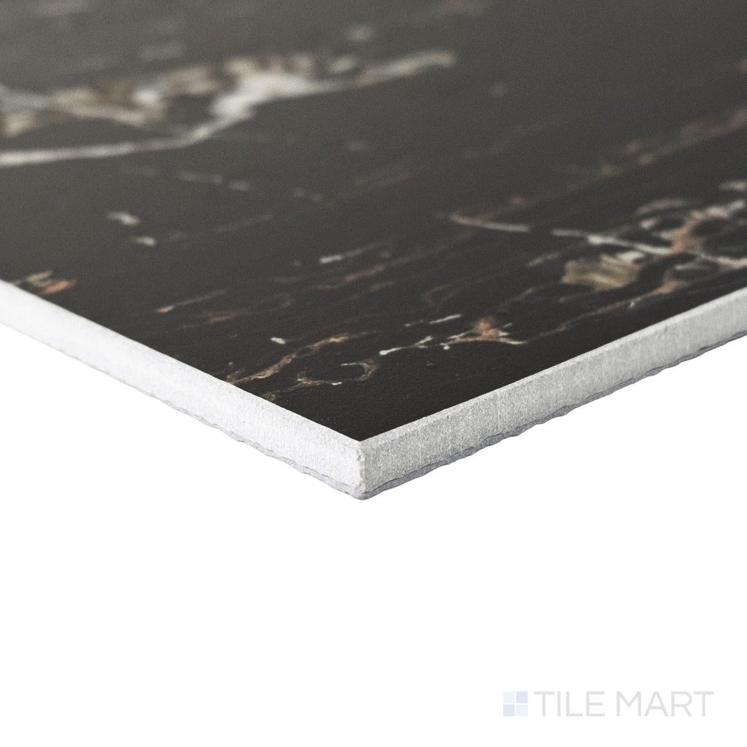 Angled corner shot of a large 24x24 Palazzo Nero natural porcelain tile showing its sharp rectified profile and commanding deep black matte surface