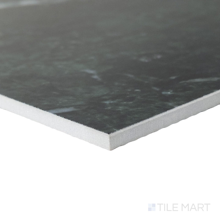 Corner perspective of a large 24x24 Palazzo Verde polished porcelain tile revealing its precise edge finish and expansive earthy green-grey gloss surface