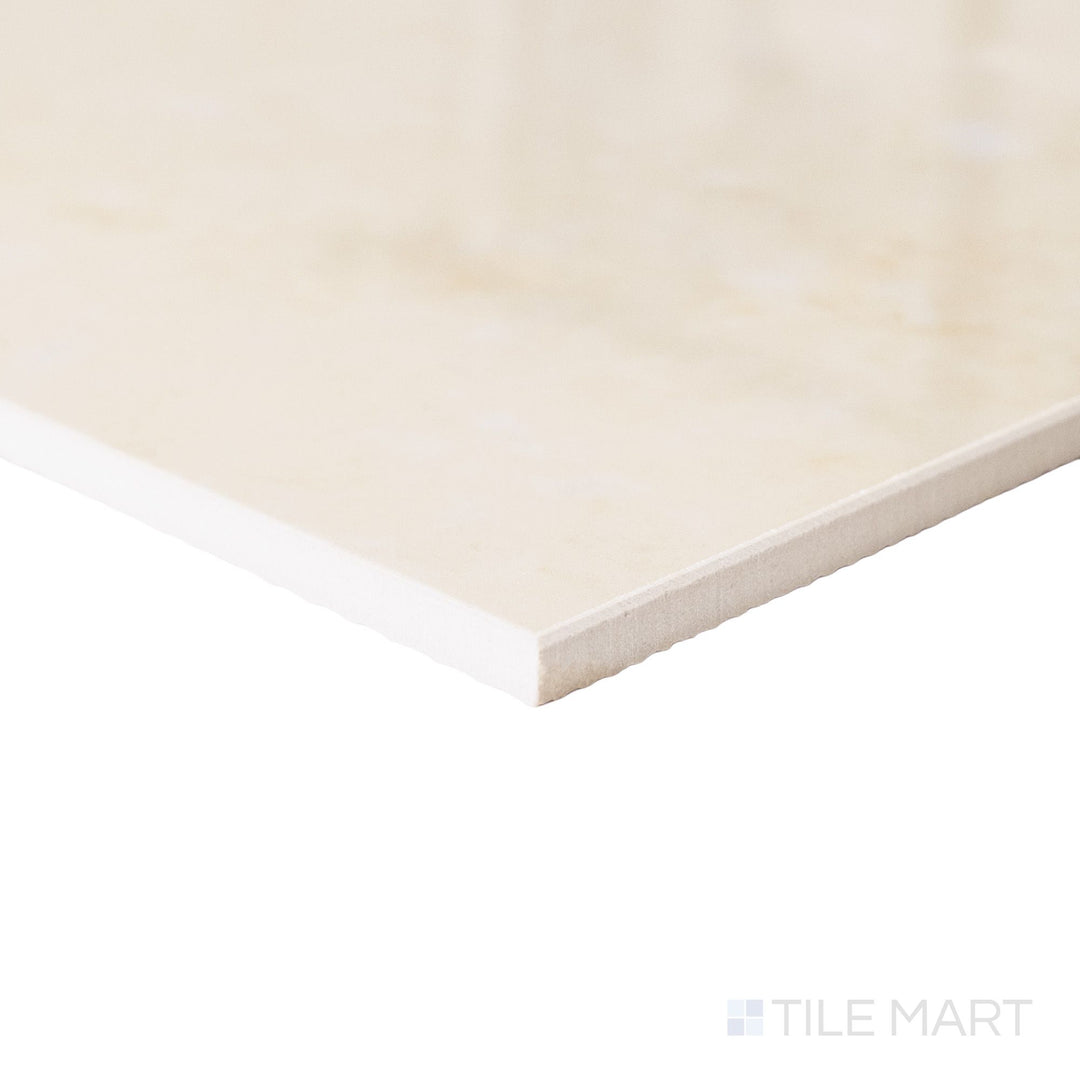 Corner angle of a large 24x24 Palazzo Crema polished porcelain tile displaying its clean rectified edge and luminous warm ivory high-gloss finish