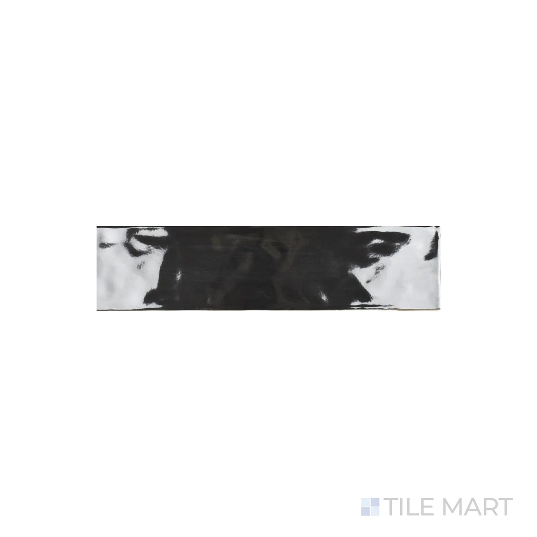 A detailed close-up of Artesano Black 3X12 Bright Ceramic showcases its deep black hue with a high-gloss finish, creating a striking modern aesthetic.