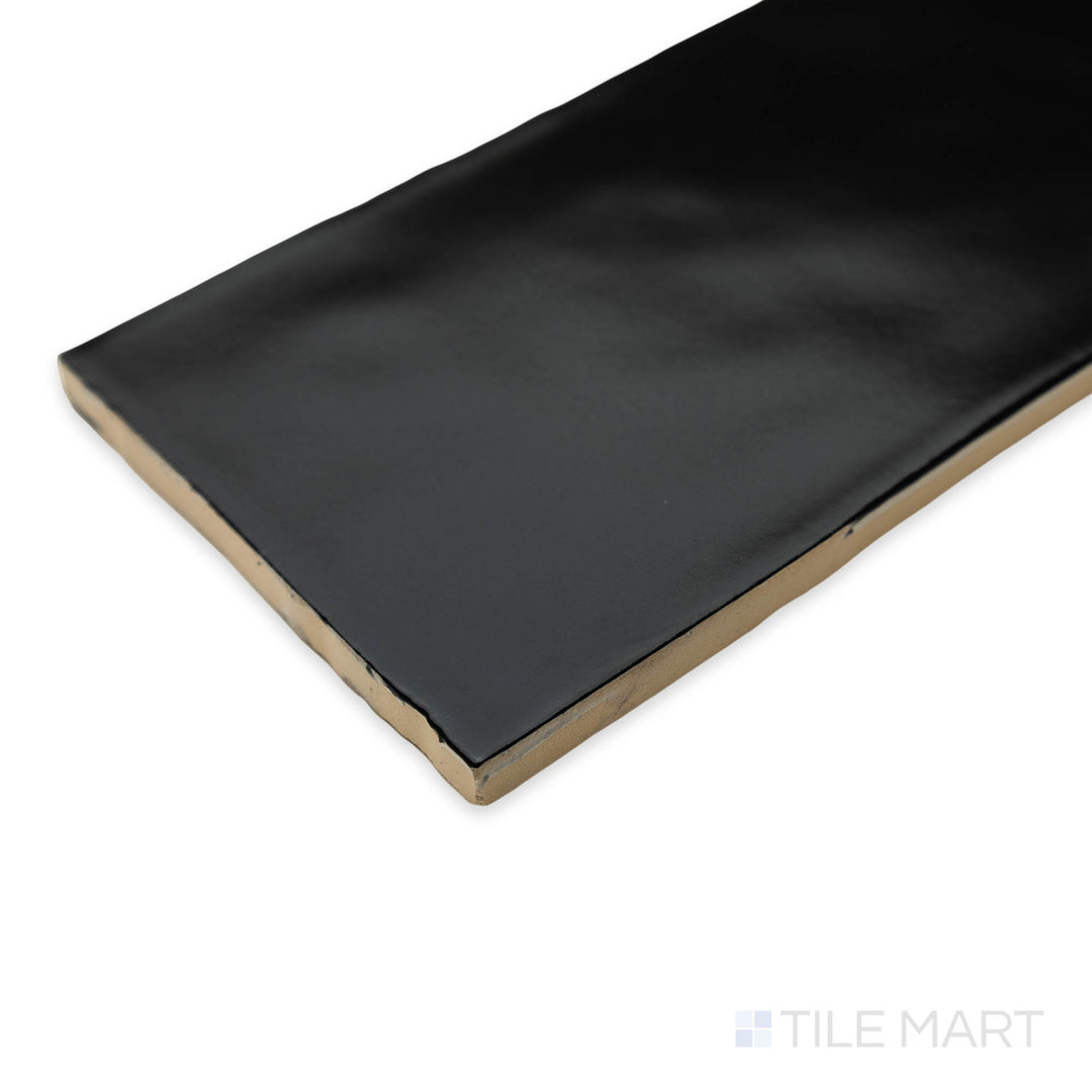 Side-angle close-up of Artesano Black 3X12 matte ceramic tile, emphasizing its bold black shade, velvety matte texture, and the structured tile placement at the corner.