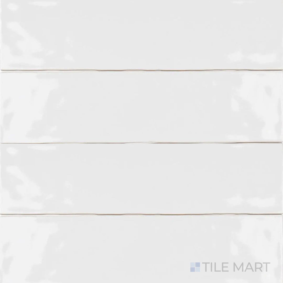 With a smooth, polished finish, the Artesano White Ice 3x12 inch bright ceramic tile stands out in this top-angle shot, reflecting light beautifully with its clean white tone.