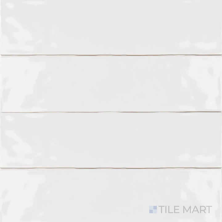 With a smooth, polished finish, the Artesano White Ice 3x12 inch bright ceramic tile stands out in this top-angle shot, reflecting light beautifully with its clean white tone.