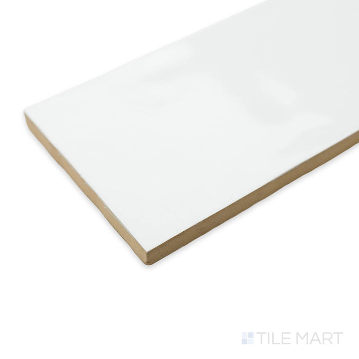 Corner shot of Artesano White Ice 3X12 bright ceramic tile, featuring a clean white hue, high-gloss sheen, and seamless alignment at the tile’s intersection.