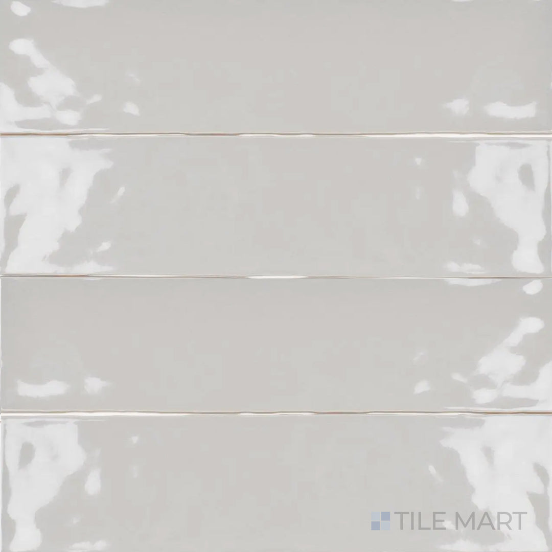 This overhead perspective of the Artesano Neu Gray 3x12 inch bright ceramic tile reveals its elegant gray tone and glossy finish, making it a versatile choice for modern interiors.