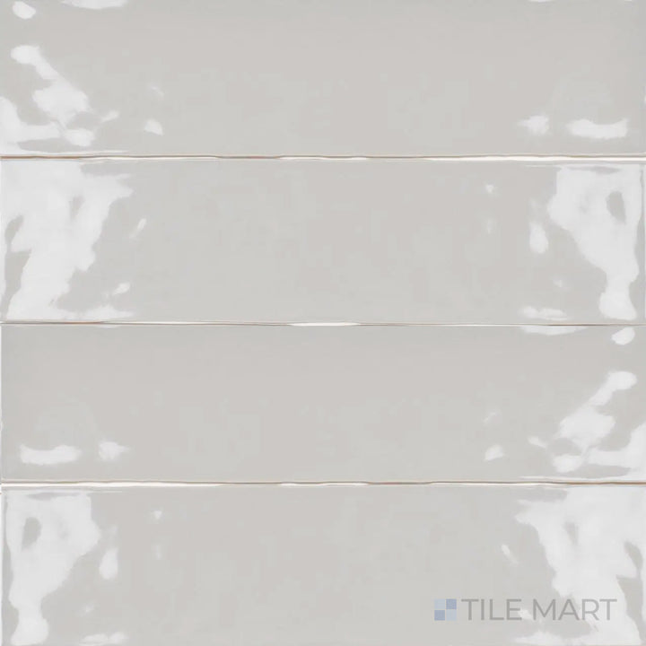 This overhead perspective of the Artesano Neu Gray 3x12 inch bright ceramic tile reveals its elegant gray tone and glossy finish, making it a versatile choice for modern interiors.