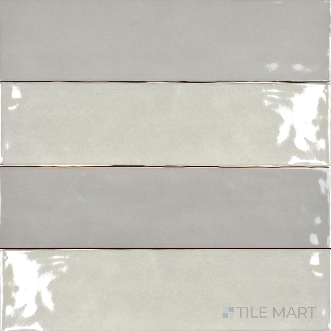 The Bar Tile Oslo 3x12 inch bright ceramic tile displays a sleek, glossy surface in a neutral tone, viewed from above to highlight its smooth finish and elongated shape.